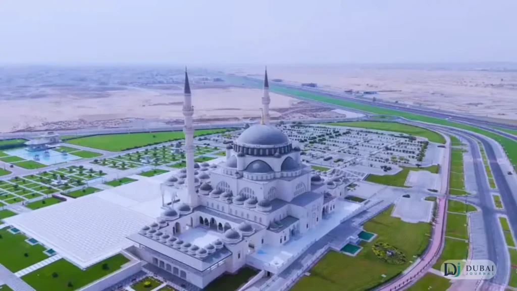 Aerial view of Sharjah Mosque with its white domes and minarets
