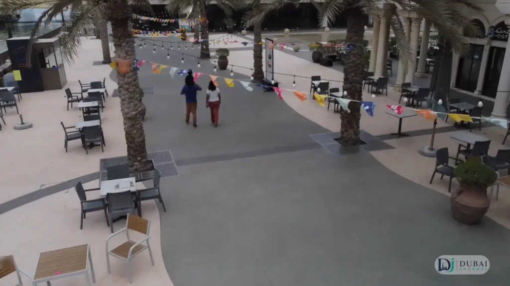 Café terraces with outdoor seating along the Al Qasba canal