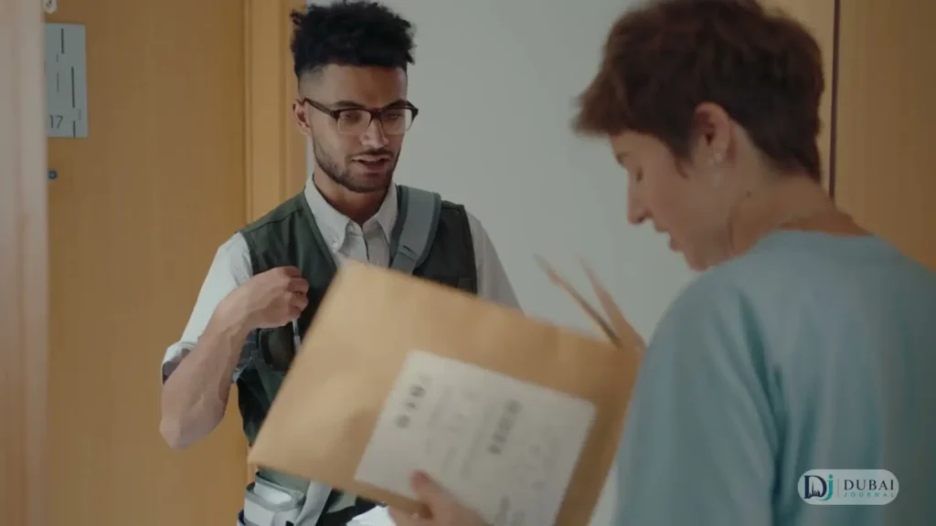 Courier handing a parcel to a customer at the door