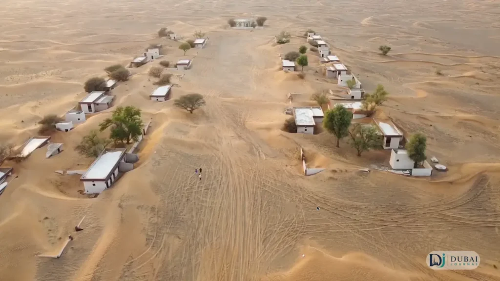 Drone aerial of Al Madam Buried Village houses in the dunes