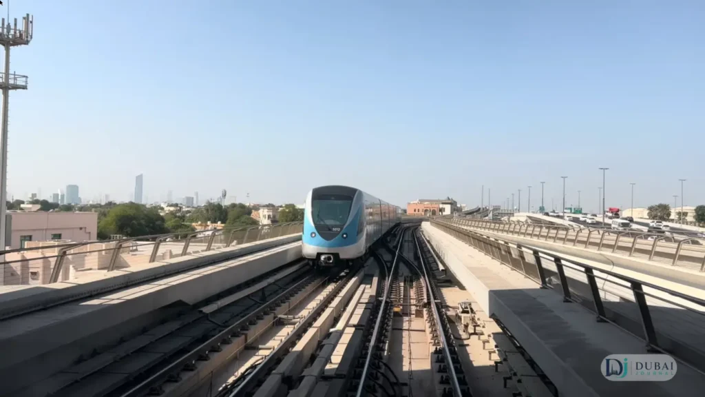Dubai Metro Red Line train on elevated tracks with Dubai skyline