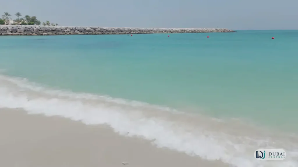 Gentle waves washing over the sandy shore of Al Khan Beach in Sharjah