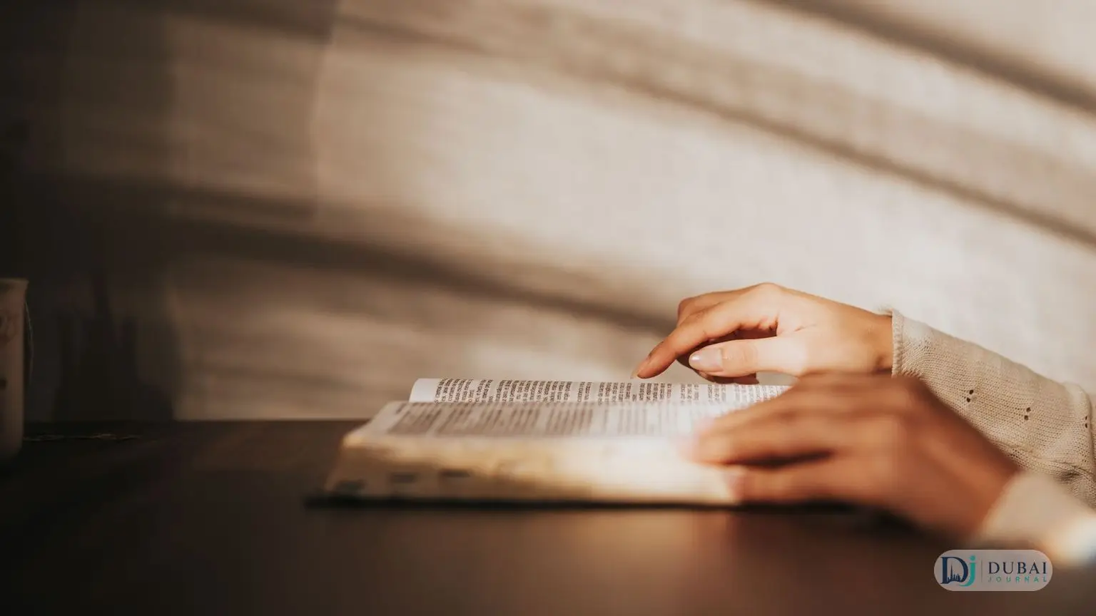 Hands resting on an open book