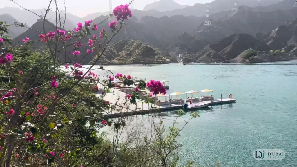 Pedal boats and kayaks docked on Al Rafisah Dam's turquoise lake
