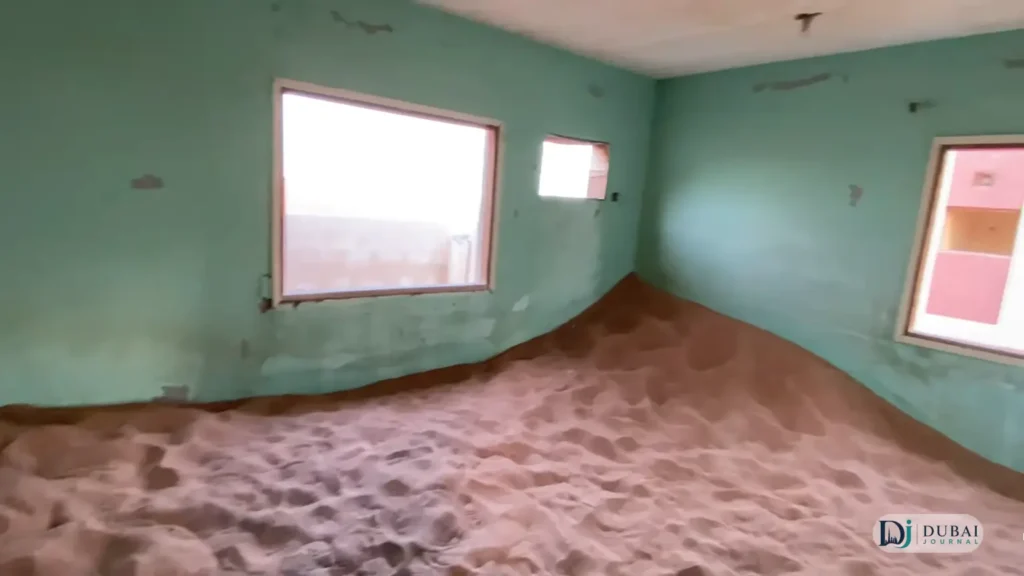 Sand-filled room inside an abandoned house at Al Madam