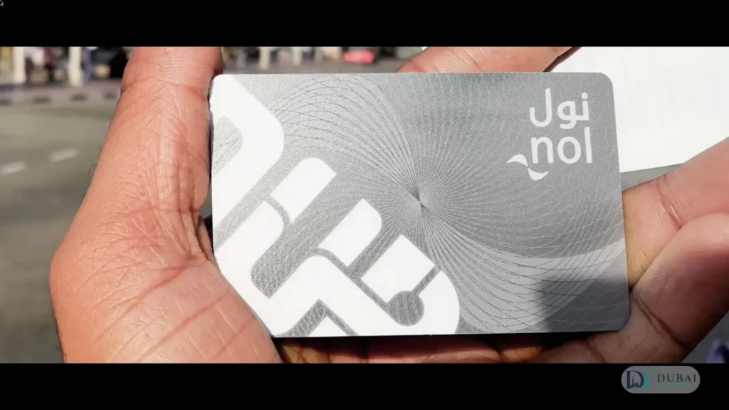Silver nol card held in hand for Dubai Metro zone fares